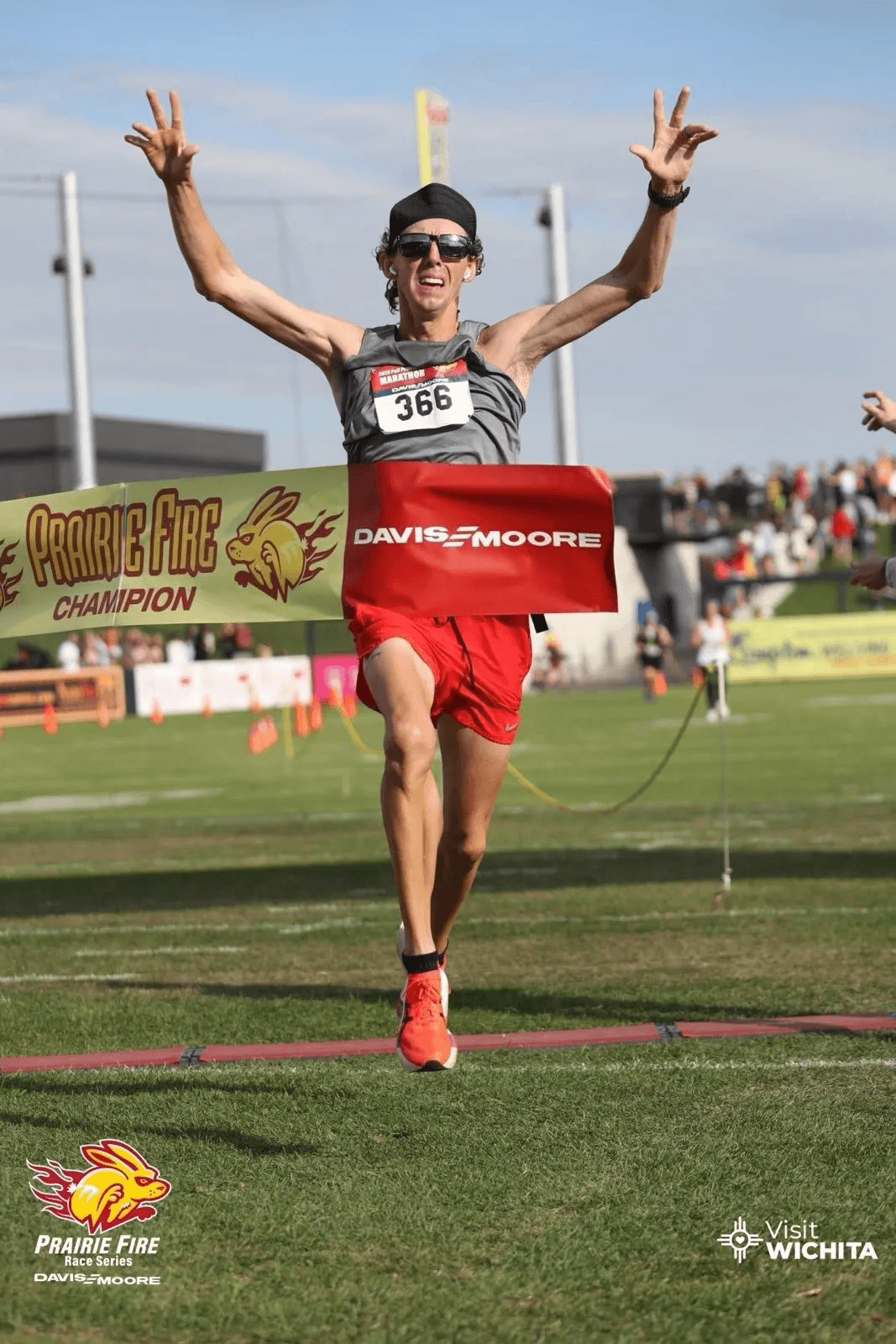 Coach Dustin Mettler crossing the Prairie Fire Marathon finish line